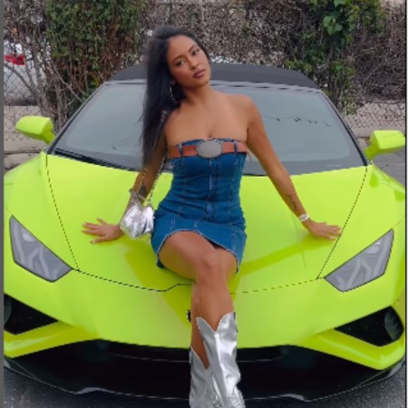 Nurys Mateo posing in front of a Lamborghini.